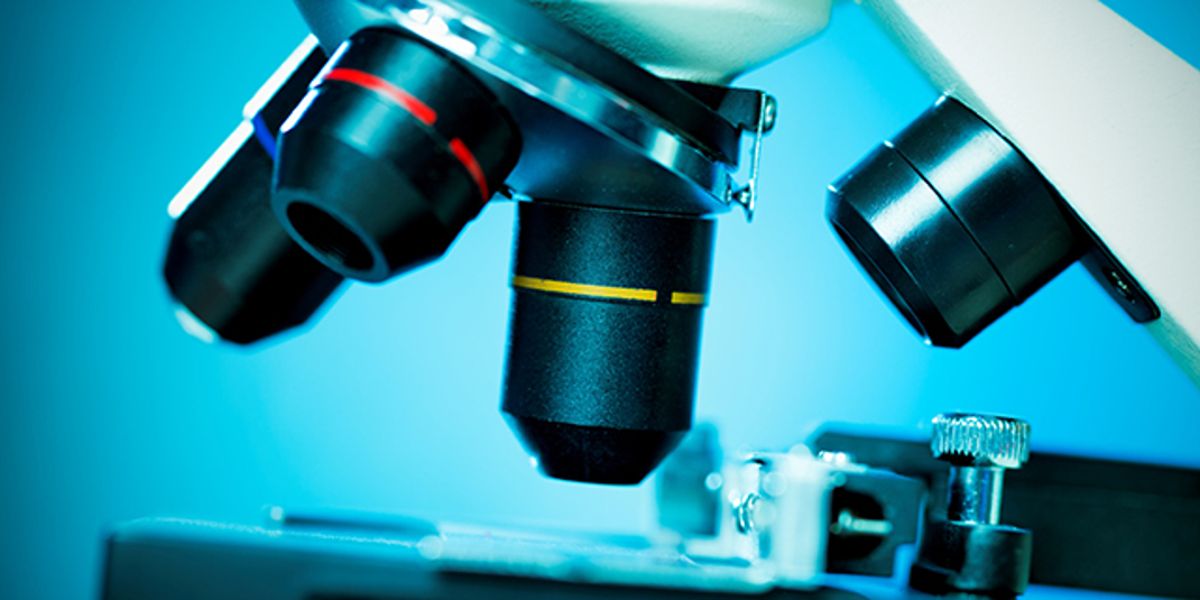 Laboratory professional working with a microscope